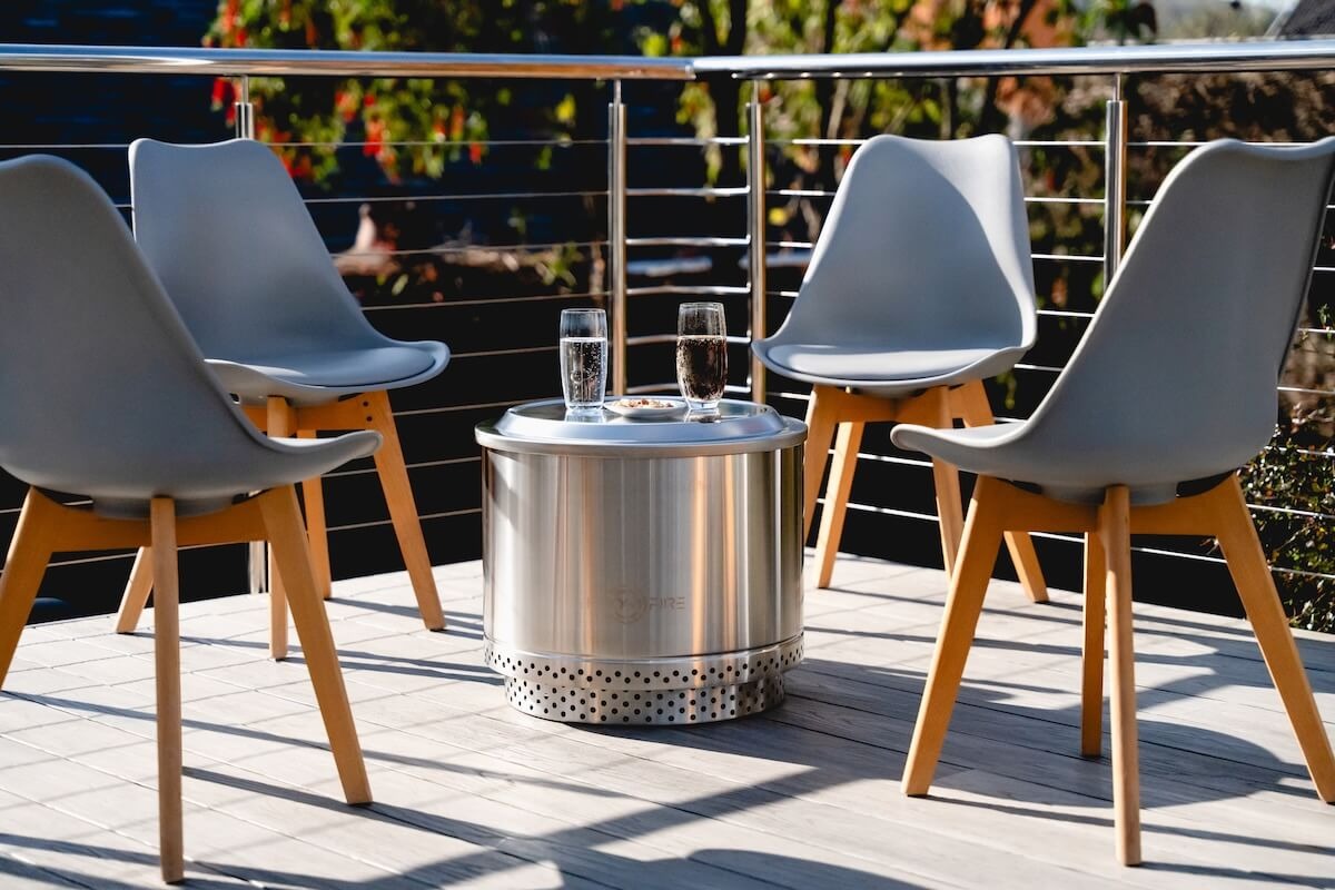 Smokeless fire pit accessories arranged on a wooden deck